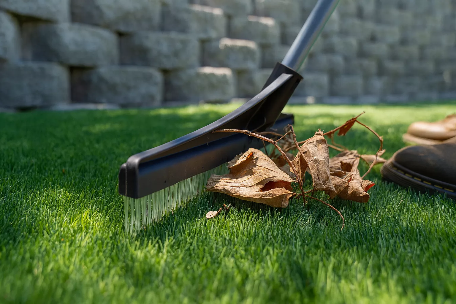 Debris removal on artificial lawn